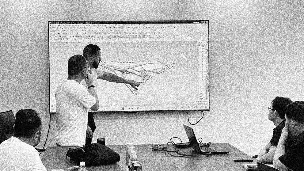 IZI Brothers engineers reviewing Hornet Bike plastic kit and seat subframe design during development meeting.